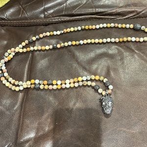 Long beaded necklace with faux diamond beads in between and skull